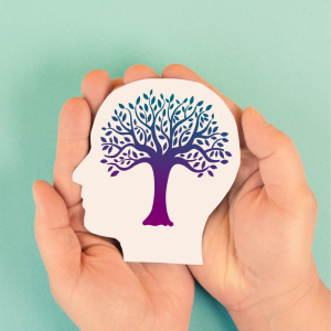 wooden head icon with a tree flourishing within it being held by two hands.