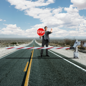 Man holding a stop sign on a road