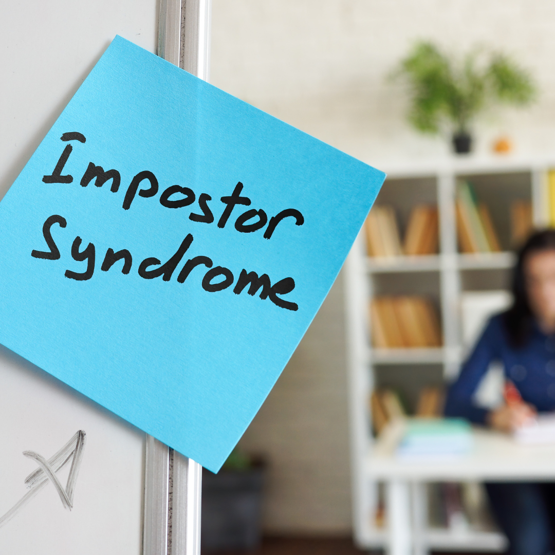 post-it saying Impostor Syndrome on a doorway.