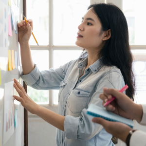 Woman writing on a white board