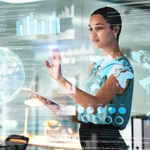 person standing in front of a futuristic transparent screen analyzing data