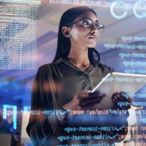 Woman with a clipboard standing in front of a digital screen