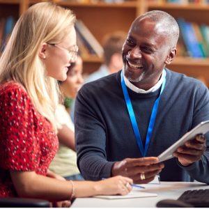 A librarian showing a user something on an ipad